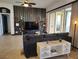 Living room with stylish decor, a dark gray sofa, large windows, and sliding glass doors to screened lanai at 1241 Riverscape St # B, Bradenton, FL 34208