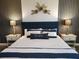 The main bedroom is adorned with tasteful decor, lamps, and decorative paneling to make it stylish and comfortable at 1241 Riverscape St # B, Bradenton, FL 34208