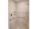 The remodeled shower features neutral tiles, a built-in seat, and convenient grab bars for added safety and accessibility at 1241 Riverscape St # B, Bradenton, FL 34208