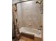 Clean bathroom shower with tiled walls, bronze fixtures, and decorative shower curtain at 1241 Riverscape St # B, Bradenton, FL 34208