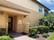 Inviting entrance showcasing the exterior with a welcoming front door, lush landscaping, and brick walkway at 1241 Riverscape St # B, Bradenton, FL 34208