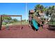 Inviting neighborhood playground, complete with a slide and swing set, surrounded by lush greenery at 1241 Riverscape St # B, Bradenton, FL 34208