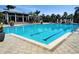 Beautiful community pool with lap lanes, set against the backdrop of a clubhouse and palm trees at 1241 Riverscape St # B, Bradenton, FL 34208