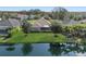 Aerial view of the backyard overlooking a tranquil pond, lush greenery and mature landscaping around the property at 12908 Crystal Clear Pl, Bradenton, FL 34211