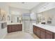 Bright bathroom featuring double sink vanity, framed mirrors, stylish lighting, and glass enclosed shower at 12908 Crystal Clear Pl, Bradenton, FL 34211