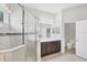 Bathroom features a glass-enclosed shower, dark wood vanity, and a separate toilet area at 12908 Crystal Clear Pl, Bradenton, FL 34211