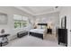 Bright bedroom with a large window, tray ceiling, a bed and dark furniture at 12908 Crystal Clear Pl, Bradenton, FL 34211