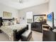 Comfortable bedroom features a large bed, TV, and dark wood furniture, creating a cozy space at 12908 Crystal Clear Pl, Bradenton, FL 34211