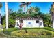 A beautifully landscaped entrance to the community featuring the 'Indigo at Lakewood Ranch' sign at 12908 Crystal Clear Pl, Bradenton, FL 34211
