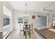 Cozy dinette area featuring a modern chandelier and natural light from the windows at 12908 Crystal Clear Pl, Bradenton, FL 34211