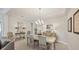 Elegant dining room features stylish chandelier, seating for six, and decorative console table at 12908 Crystal Clear Pl, Bradenton, FL 34211