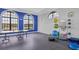 Bright exercise room featuring large windows, a blue accent wall, and fitness equipment at 12908 Crystal Clear Pl, Bradenton, FL 34211