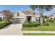 Charming home with stone accents, lush landscaping, and a well-manicured front lawn at 12908 Crystal Clear Pl, Bradenton, FL 34211
