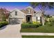 Charming home with stone accents, lush landscaping, and a well-manicured front lawn at 12908 Crystal Clear Pl, Bradenton, FL 34211