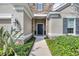 Inviting front entrance with stone accents, lush landscaping, and stylish exterior lighting at 12908 Crystal Clear Pl, Bradenton, FL 34211