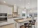 Well-equipped kitchen with stainless steel appliances, granite countertops, and a functional center island with seating at 12908 Crystal Clear Pl, Bradenton, FL 34211