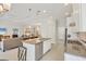 Open kitchen with granite countertops, stainless steel appliances, island seating and seamless view to the living space at 12908 Crystal Clear Pl, Bradenton, FL 34211