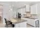 Stylish kitchen featuring granite counters, white cabinetry, stainless appliances, and an island with seating at 12908 Crystal Clear Pl, Bradenton, FL 34211