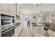Modern kitchen with stainless steel appliances, granite counters, island seating and adjacent dinette at 12908 Crystal Clear Pl, Bradenton, FL 34211