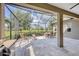 This spacious screened-in lanai offers ample seating and dining areas with views of the lush backyard at 12908 Crystal Clear Pl, Bradenton, FL 34211