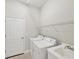 This laundry room has a washer, dryer, utility sink, door and wire shelving at 12908 Crystal Clear Pl, Bradenton, FL 34211