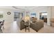 Bright living room featuring tile floors, neutral decor, and sliding glass doors to outdoor patio at 12908 Crystal Clear Pl, Bradenton, FL 34211