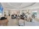 Open-concept living room showcasing tile floors, tray ceiling, and modern furnishings at 12908 Crystal Clear Pl, Bradenton, FL 34211
