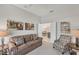 Cozy seating area with sofa and art, leading to the dining room, creating a welcoming atmosphere at 12908 Crystal Clear Pl, Bradenton, FL 34211