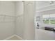 Simple walk-in closet leads to the Primary bedroom with serene water views and comfortable furnishings at 12908 Crystal Clear Pl, Bradenton, FL 34211