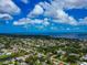 Aerial neighborhood view featuring a blue house near a lake and the beautiful ocean in the background at 1312 73Rd Nw St, Bradenton, FL 34209