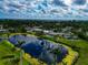 Aerial view of a lake community, reflecting the sky, showcasing the property and neighborhood setting at 1312 73Rd Nw St, Bradenton, FL 34209
