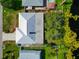 Aerial view of a home with a light grey metal roof and lush green surroundings near a lake at 1312 73Rd Nw St, Bradenton, FL 34209