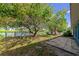 Charming backyard featuring a patio, lush trees, and serene pond views, perfect for relaxation and outdoor enjoyment at 1312 73Rd Nw St, Bradenton, FL 34209