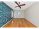Bedroom with hardwood floors and floral wallpaper accent wall at 1312 73Rd Nw St, Bradenton, FL 34209