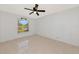 This bedroom features tile flooring, a ceiling fan, and a serene view from its window at 1312 73Rd Nw St, Bradenton, FL 34209