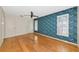Bedroom with hardwood floors, ceiling fan and unique floral wallpaper at 1312 73Rd Nw St, Bradenton, FL 34209