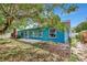Exterior view of home featuring a patio and bright paint, complemented by mature trees and ample outdoor space at 1312 73Rd Nw St, Bradenton, FL 34209