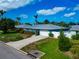 Lovely blue single-story home with a grey metal roof, manicured lawn, and concrete driveway at 1312 73Rd Nw St, Bradenton, FL 34209