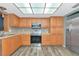Charming kitchen with stainless steel appliances, warm wood cabinets, and mosaic tile backsplash at 1312 73Rd Nw St, Bradenton, FL 34209