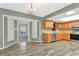 Well-lit kitchen featuring stainless steel appliances, warm wood cabinets, and large open access to sunroom at 1312 73Rd Nw St, Bradenton, FL 34209