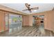 Open concept living area with wood-look floors leading to the kitchen and sunroom at 1312 73Rd Nw St, Bradenton, FL 34209