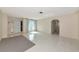 Bright living room features neutral walls, light tile floor, an arched doorway, and front entry at 1312 73Rd Nw St, Bradenton, FL 34209