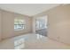 A room with a window, white tile flooring, and an open doorway to another room at 1312 73Rd Nw St, Bradenton, FL 34209