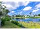 Scenic view of a pond surrounded by lush greenery and palm trees, creating a tranquil and picturesque landscape at 1312 73Rd Nw St, Bradenton, FL 34209