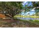 Beautiful pond view from the backyard, enhanced by mature trees and landscaping creating a peaceful setting at 1312 73Rd Nw St, Bradenton, FL 34209