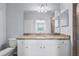 Bathroom boasts granite countertops, framed mirrors, and tiled floors at 17118 Vardon Ter # 404, Bradenton, FL 34211