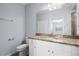 Updated bathroom showcasing granite countertop, tiled shower, and neutral colors at 17118 Vardon Ter # 404, Bradenton, FL 34211