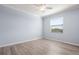 Bright bedroom with neutral paint, ceiling fan, and wood-look flooring at 17118 Vardon Ter # 404, Bradenton, FL 34211