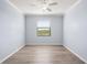 Cozy bedroom offers wood-look flooring and natural light from window at 17118 Vardon Ter # 404, Bradenton, FL 34211