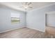 Bedroom featuring light walls, a ceiling fan, and wood-look flooring at 17118 Vardon Ter # 404, Bradenton, FL 34211